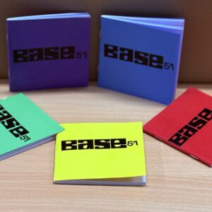 Image of 5 notebooks with Base 51 logo in black on the front. Colour of notebooks are green, yellow, red, blue and purple.