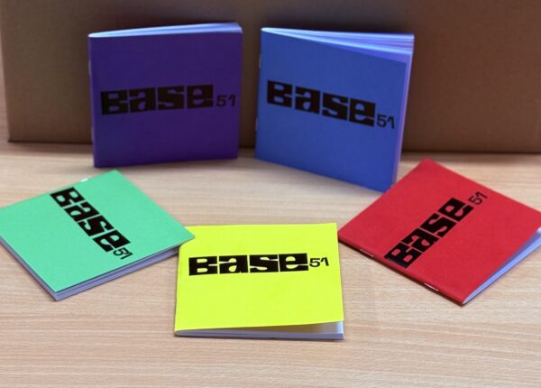 Image of 5 notebooks with Base 51 logo in black on the front. Colour of notebooks are green, yellow, red, blue and purple.